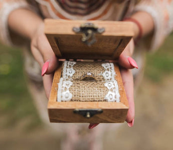 Personalized rustic wedding ring box with wooden texture and metal hardware, adding elegance and charm to the wedding ceremony.